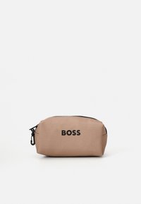 Rudas audinio kosmetikos maišelis su užtrauktuku, su juodu "BOSS" logotipu priekyje. Lygus paviršius ir apvalios formos.