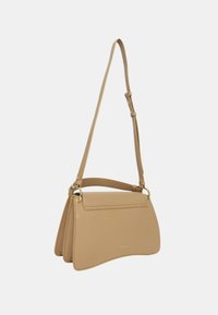 Borsa a spalla in pelle beige con forma curvata, tracolla regolabile e hardware in tono oro. Presenta una texture liscia e una chiusura a pattina semplice.