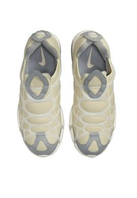 Nike sneakers with a beige and grey design, featuring a mesh upper, plastic overlays, and a unique geometric pattern for enhanced support.