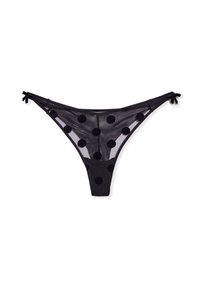 String noir transparent orné de grands pois noirs. Fins straps avec des nœuds de chaque côté. Matériau léger et semi-transparent.