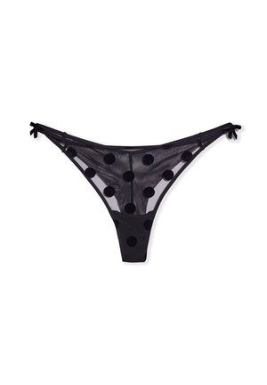 Tanga negra transparente con grandes lunares negros. Delicadas tiras con lazos a cada lado. Material ligero y semitransparente.