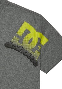 Gray short-sleeve t-shirt featuring a large yellow and black graphic logo on the front, with a textured fabric.