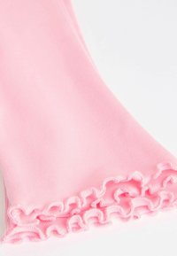 Rózsaszín pamut leggings fodros díszítéssel a bokán. Sima textúra, formázott fazon és puha anyag.