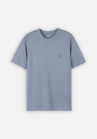 T-shirt en coton bleu clair à manches courtes et col rond. Présente un design graphique subtil sur le côté gauche de la poitrine. Coupe simple et décontractée.