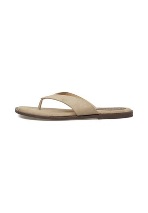 Sandalia beige de ante con tira ancha y suela plana marrón, vista de lado sobre fondo blanco.