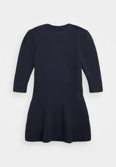 Knit dress in dark navy with long sleeves, ribbed neckline, and flared hem. Features a small purple accent detail on the sleeve.