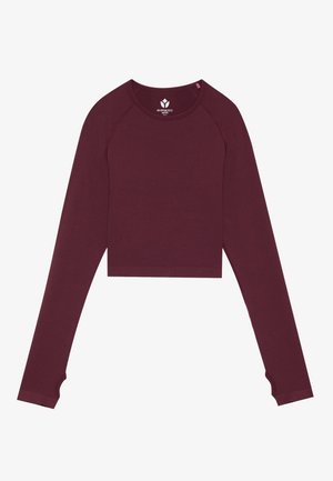 Burgundy cropped long-sleeve top with a ribbed texture and finger hole accents on sleeves. Made of soft, stretchy material.
