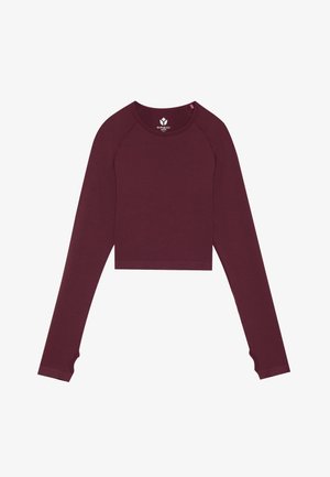 Burgunderrød cropped langærmet top med rillet struktur og fingerhul-accenter på ærmerne. Fremstillet af blødt, strækbart materiale.