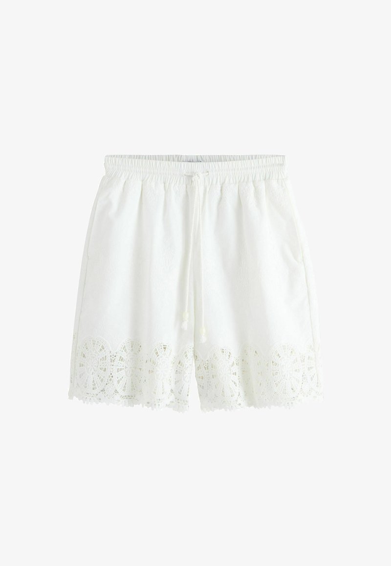 Short blanc à taille élastique avec cordon de serrage et dentelle délicate le long de l'ourlet.