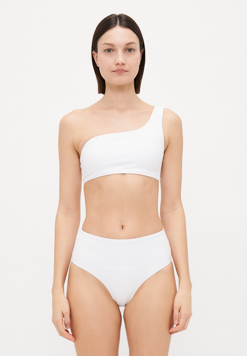 White bikini set featuring a one-shoulder top and high-waisted bottoms. Smooth texture with no patterns or accents. Minimalist design.