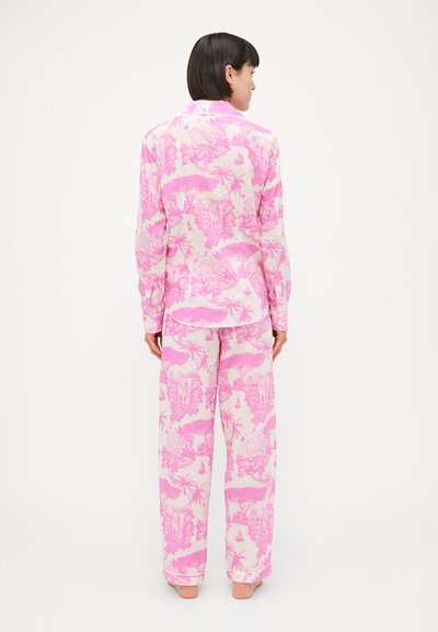 Pink tropical-patterned pajama set made of soft fabric; features long sleeves, relaxed fit top, and wide-leg pants with an elastic waistband.