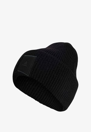 Black knitted beanie with a ribbed texture. Features a black rectangular logo patch on one side. Soft fabric for warmth.