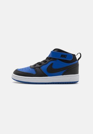 Nike mid-top sneakers featuring a blue and black leather exterior, white midsole, black accents, and a hook-and-loop strap for closure.