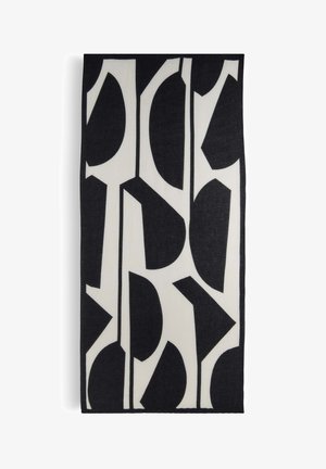 Schwarz-weißes, gemustertes Wandbehang mit abstrakten Formen und Linien. Das Material wirkt strukturiert und mit einem kontrastreichen Design versehen.