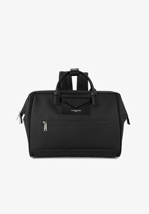 Sac à main Lancaster Paris noir avec doubles poignées, poche zippée à l'avant et bretelles rembourrées visibles sur fond blanc.