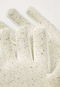 Witte handschoenen met zwarte spikkels, gemaakt van flexibel materiaal, met een gestructureerd oppervlak en een duidelijke vinger vorm voor grip en behendigheid.