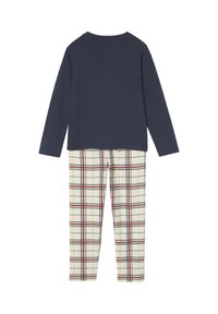 Navy long-sleeve top with a round neck paired with cream plaid pants featuring red and black lines. Soft cotton fabric, relaxed fit.