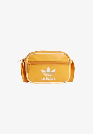 Sac bandoulière adidas jaune avec une finition texturée, logo blanc, fermeture éclair, poche avant et sangle ajustable.