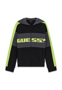 Black zip-up hoodie featuring gray and neon green stripes, large "GUESS?" logo across the chest, and a drawstring hood. Soft fabric texture.