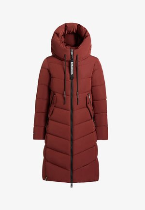 Pitkä ruosteenvärinen toppatakki, jossa on korkea kaulus, keskellä vetoketju, sivuissa vetoketjutaskut ja mustat narut, joissa on brändilogo.