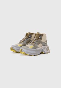 Gray and beige high-top sneakers with yellow accents, textured fabric, reinforced toe, and metal eyelets. Features a logo on the side.