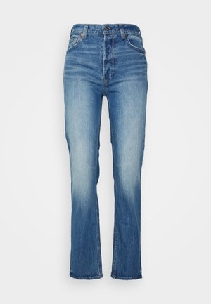 Jean bleu taille haute, coupe droite, avec devant délavé, fermeture par bouton et zip, passants de ceinture, poches avant et arrière.