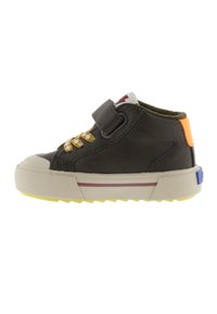 Child's black sneaker with yellow laces, beige sole with purple stripe, orange heel tab, and Velcro strap on white background.