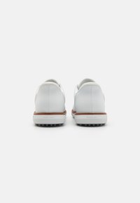 White leather golf shoes with a smooth texture, featuring a tan rubber sole and traction spikes, designed for performance and comfort.