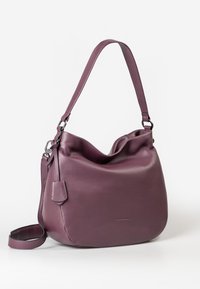 Purple leather shoulder bag with a slouchy design, textured surface, adjustable strap, and a small tag detail on the side.