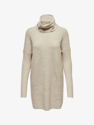 Beige turtleneck sweater with a loose fit, long sleeves, ribbed texture, and drop shoulders, made from a soft knit fabric.