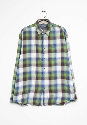 Chemise à manches longues à boutons avec motif à carreaux vert, bleu, marron et blanc, suspendue à un cintre noir sur fond blanc.