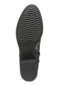 Suela de zapato de goma negra con textura ondulada y perforaciones, con el logo de Geox. Forma plana y ovalada con un acabado suave.