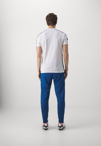 Nike Performance DRI-FIT ACADEMY PANT - Donji dijelovi trenirke - court blue/aquarius blue