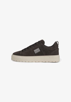 Dunkelbrauner Wildleder-Low-Top-Sneaker mit schwarzen Schnürsenkeln, beiger dicker Sohle und kleinem rechteckigem Label an der Seite.