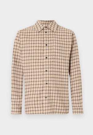 Beige langermet skjorte med knapper, svart rutemønster og enkelt brystlomme, lagt flatt på hvit bakgrunn.