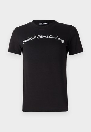 Black cotton t-shirt with short sleeves. Features white embroidered text "Versace Jeans Couture" in a curved style across the chest.