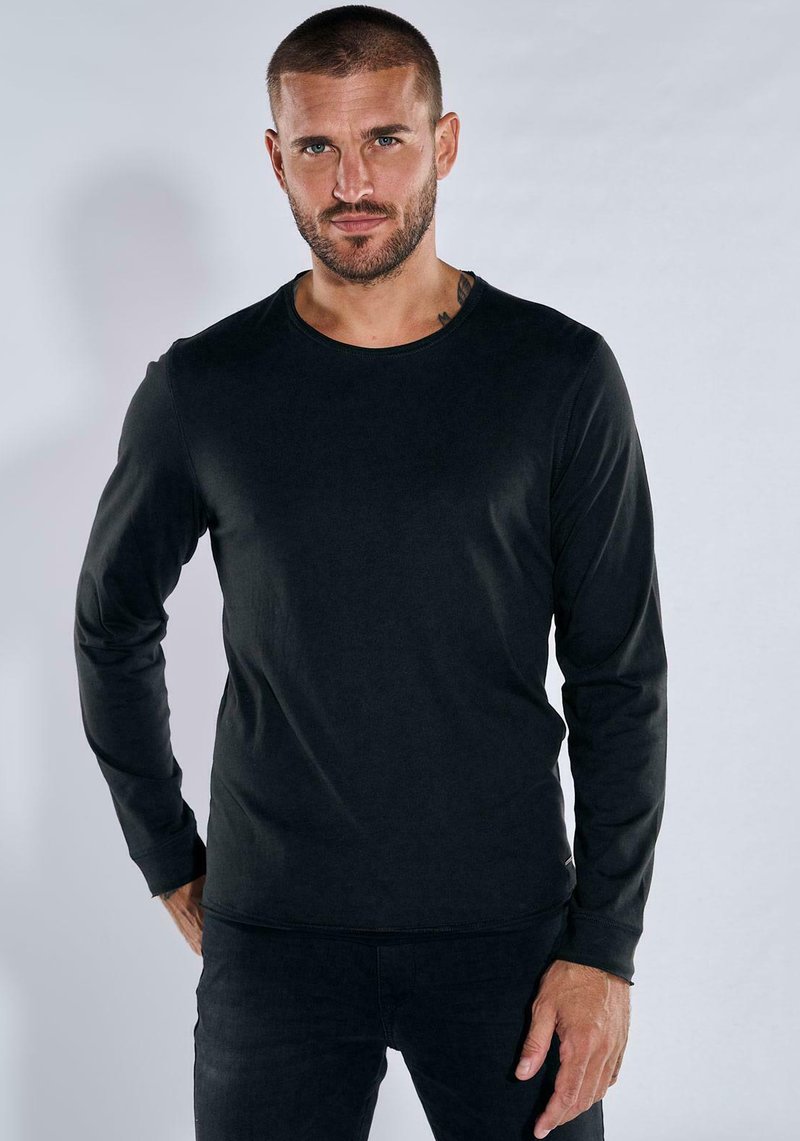 Black long-sleeve shirt made of smooth material, featuring a round neckline and fitted design. Subtle stitching detail along the hems.