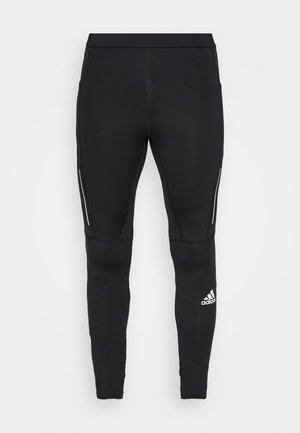 Black athletic leggings featuring a form-fitting design, made of stretchy material, with reflective side accents and a logo on the lower leg.