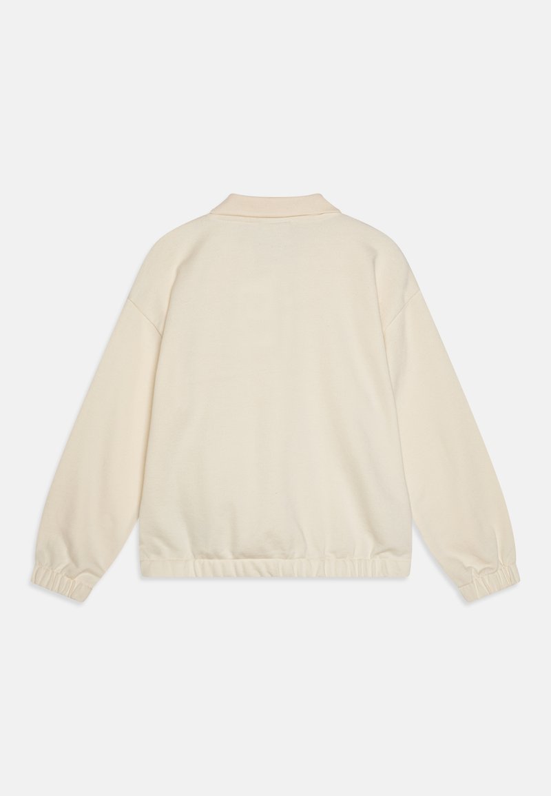 Sweatshirt leggero color crema con colletto, polsini elasticizzati e orlo arricciato per una vestibilità rilassata. Texture morbida e liscia.