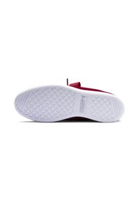 Red sneaker with a flat white rubber sole featuring a textured pattern and a logo. The upper design includes a loop for easy wear.