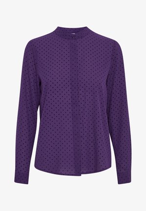 Paarse blouse met lange mouwen met kleine zwarte stippen, knoopmanchet en een enkele bovenste knoopsluiting bij de hoge halslijn.