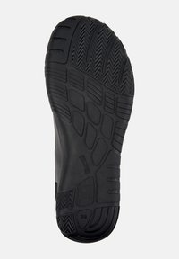 Black rubber shoe sole with a textured tread pattern, featuring various grooves and ridges for traction. Marked with "Camper" and size 38.
