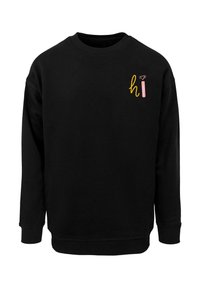 Must beanie kootiga, pikkade varrukatega ja rinnal on väike mitmevärviline "tere" graafika. Pehme kangastekstuur.