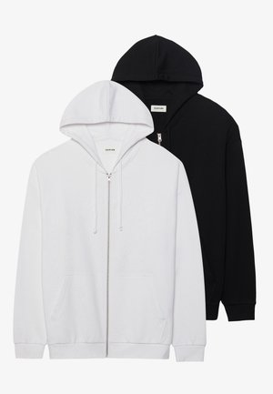 Two zip-up hoodies in black and white, featuring drawstring hoods, kangaroo pockets, ribbed cuffs, and soft fabric texture.