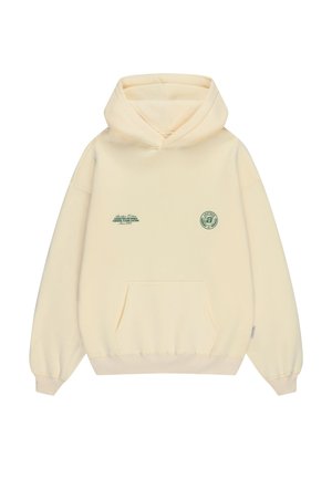 Cream-colored hoodie with front kangaroo pocket, small green text on left chest, and circular green emblem on right chest.