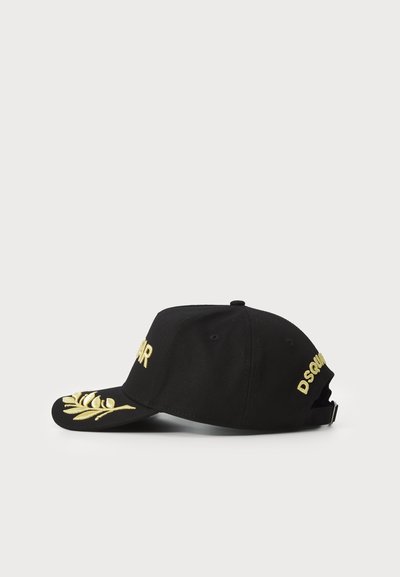 Black baseball cap featuring yellow embroidered text and a leaf design on the visor. Adjustable back strap. Cotton fabric.