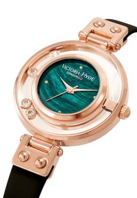 Reloj de oro rosa con esfera en tonos azules, acentos de cristal transparente y correa de cuero negro. Presenta una caja de vidrio redonda y un diseño minimalista.