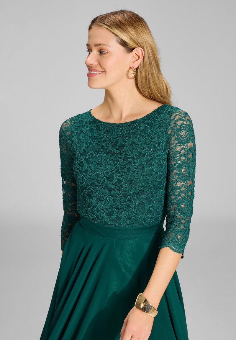 slim fit dress slacks Zapaka Women Dark Green Long Mother of The Bride Dress Mermaid Long Sleeves Lace Wedding Guest Dress with Slit, Dark Green / US18W main image 1
