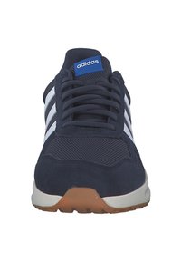 Navy blue sneaker with mesh and suede upper, three white stripes, laced front, and gum rubber sole. Adidas logo on tongue.