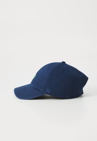 Navy blue cotton baseball cap with curved brim, featuring embroidered green logo. Six-panel design with eyelets for ventilation.